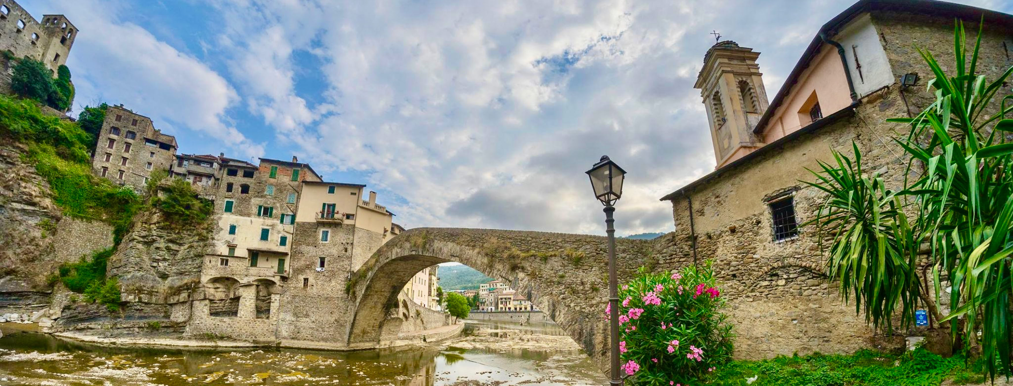 Situé dans l'arrière-pays ligure, à quelques kilomètres seulement de Vintimille, ce petit village plein de charme semble figé dans le temps. Traversé par la rivière Nervia et dominé par les ruines du Castello dei Doria, Dolceacqua offre un décor typiquement italien entre vieilles pierres, ruelles médiévales et collines couvertes d'oliviers.